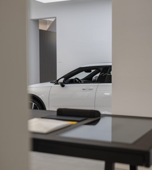 a white car is parked in a showroom